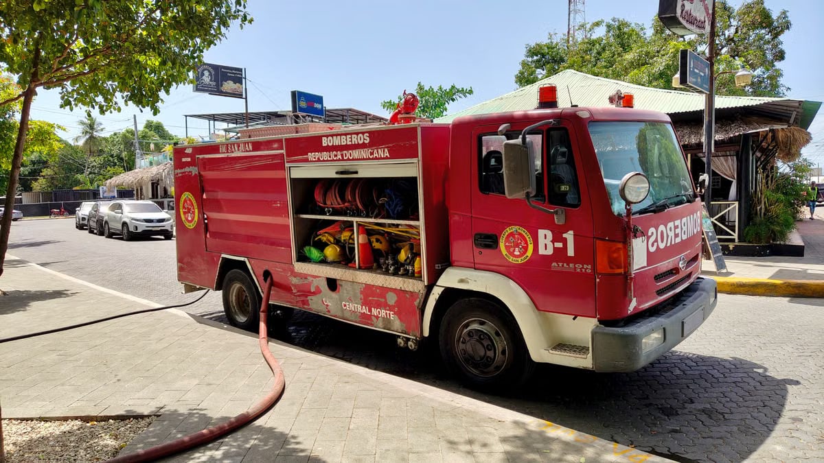Bright red fire truck on sunny Rio San Juan street in Dominican Republic.